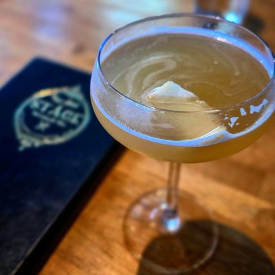 Artisanal cocktail in classic coupe glass with hand-carved ice at Stage restaurant, Georgia