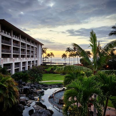 Blue hour tropical landscape with volcanic rock pools and palm trees at Fairmont Orchid, Big Island, Hawaii