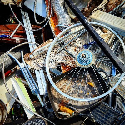 Bicycle wheel, aluminum pan, and tangled scrap metal at a material recovery facility, Birmingham, Alabama